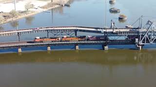 Ft. Madison Iowa, Westbound BNSF crossing swing bridge and catching Amtrak EB on Illinois side.