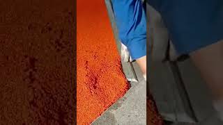 Installing A Bright Orange Textured Surface Using A Professional Trowel