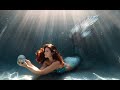Relaxing mermaid swimming underwater