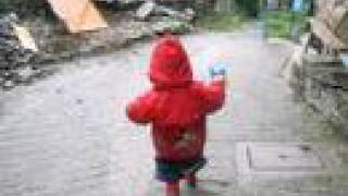 Return to Topolo. Little boy in the rain in Italy.