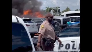 Cars ON FIRE at Dolphins-Patriots game parking lot flames at Hard Rock Stadium while cop watches