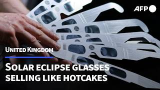 Queue for eclipse glasses outside London tube bakery as solar event nears | AFP