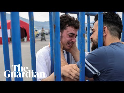 Tearful Greece shipwreck survivor reunites with brother through metal fence