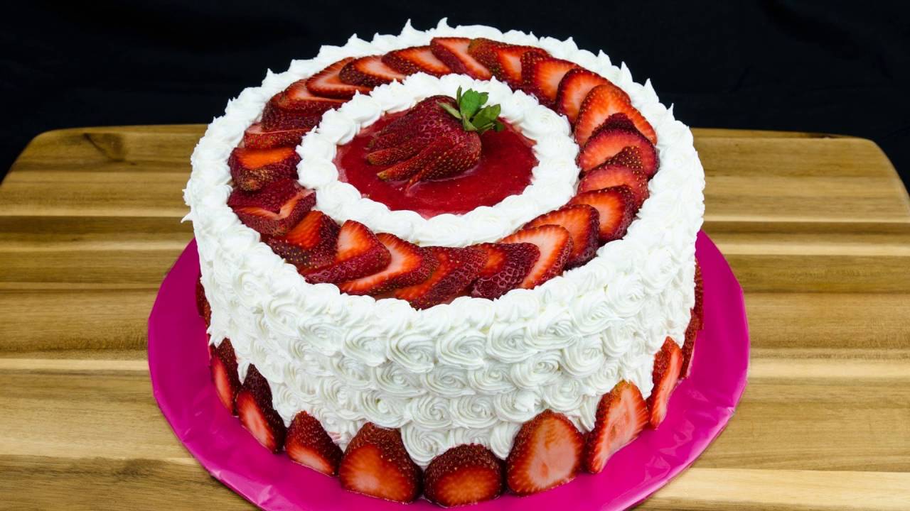 Putting Fresh Strawberries On A Cake Putting Fresh Strawberries On A Cake