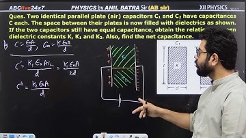 Two identical parallel plate (air) capacitors C1 and C2 have capacitances C each. The space between