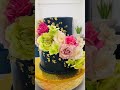 Black cake design with fresh flowers