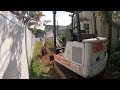 Bobcat325 uncovering a house