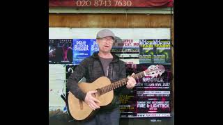 fake busking with a guitar from a skip