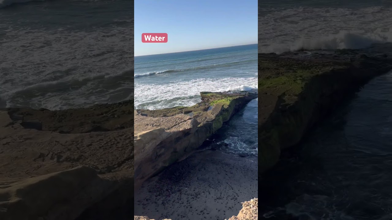 Ocean rolling to the cliffs & beach. Quiet afternoon sun.