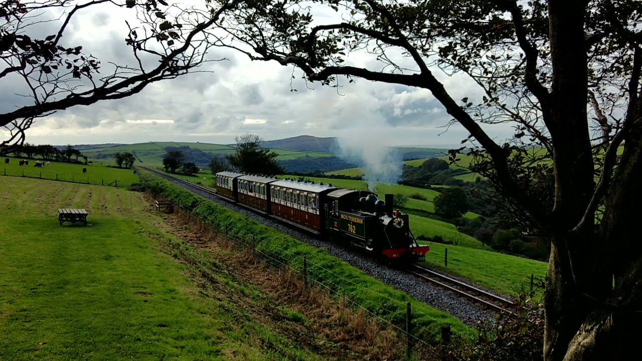 Baldwin 762 Lyn draws into Woody Bay station with a rake of authentic L&B carriages.