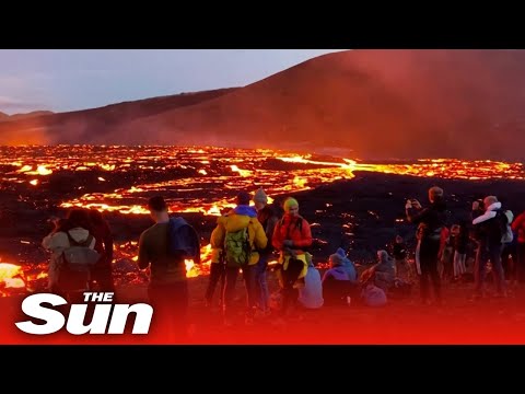 People gather to watch epic Icelandic volcano eruption fire show.