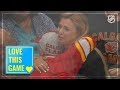 Selfless young fan hands a puck to an appreciative girl