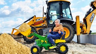 Excavator JCB 3CX Eco and Tractor John Deere digging the sand