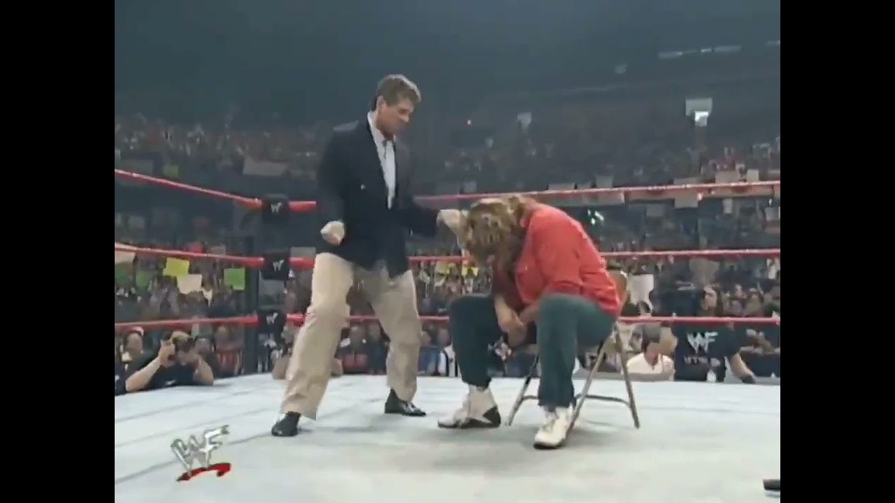 vince mcmahon dances to dude love's entrance theme while mick foley sits like a scolded dog
