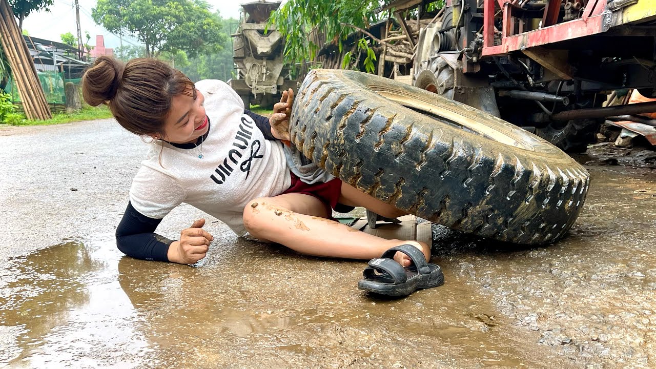 Female mechanic repairs and replaces tractor rivets