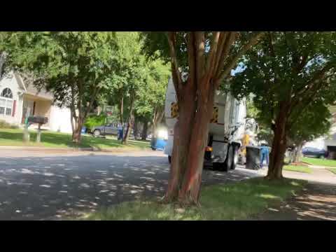 City of Virginia Beach Virginia trash truck running over recycle can