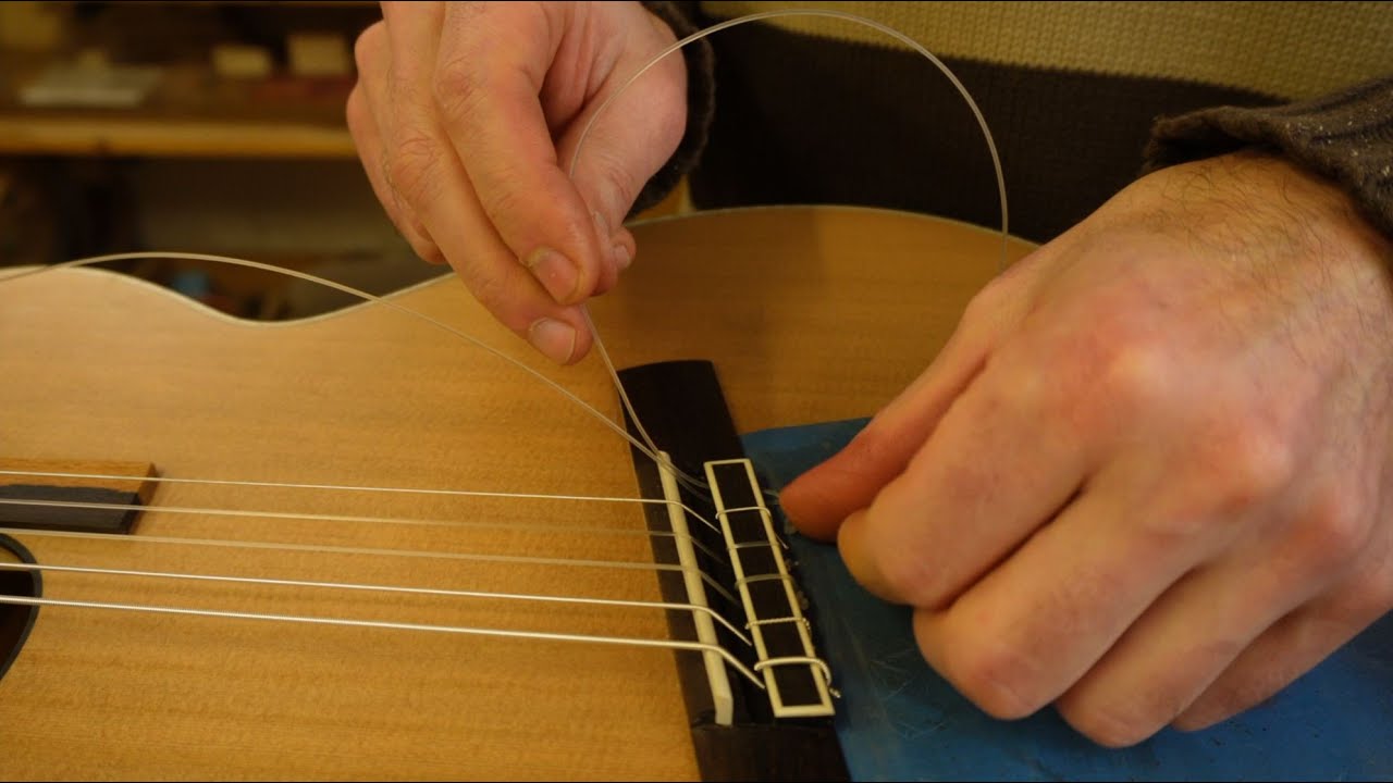Attach guitar string to double hole bridge by Daniel Zucali YouTube