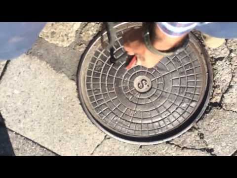 Surveyor Manny shows kids how to dip a manhole!
