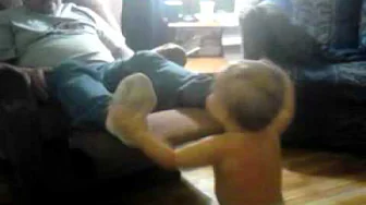 Baby tickles Daddy's feet