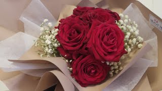 Red roses with baby breath floral bouquet