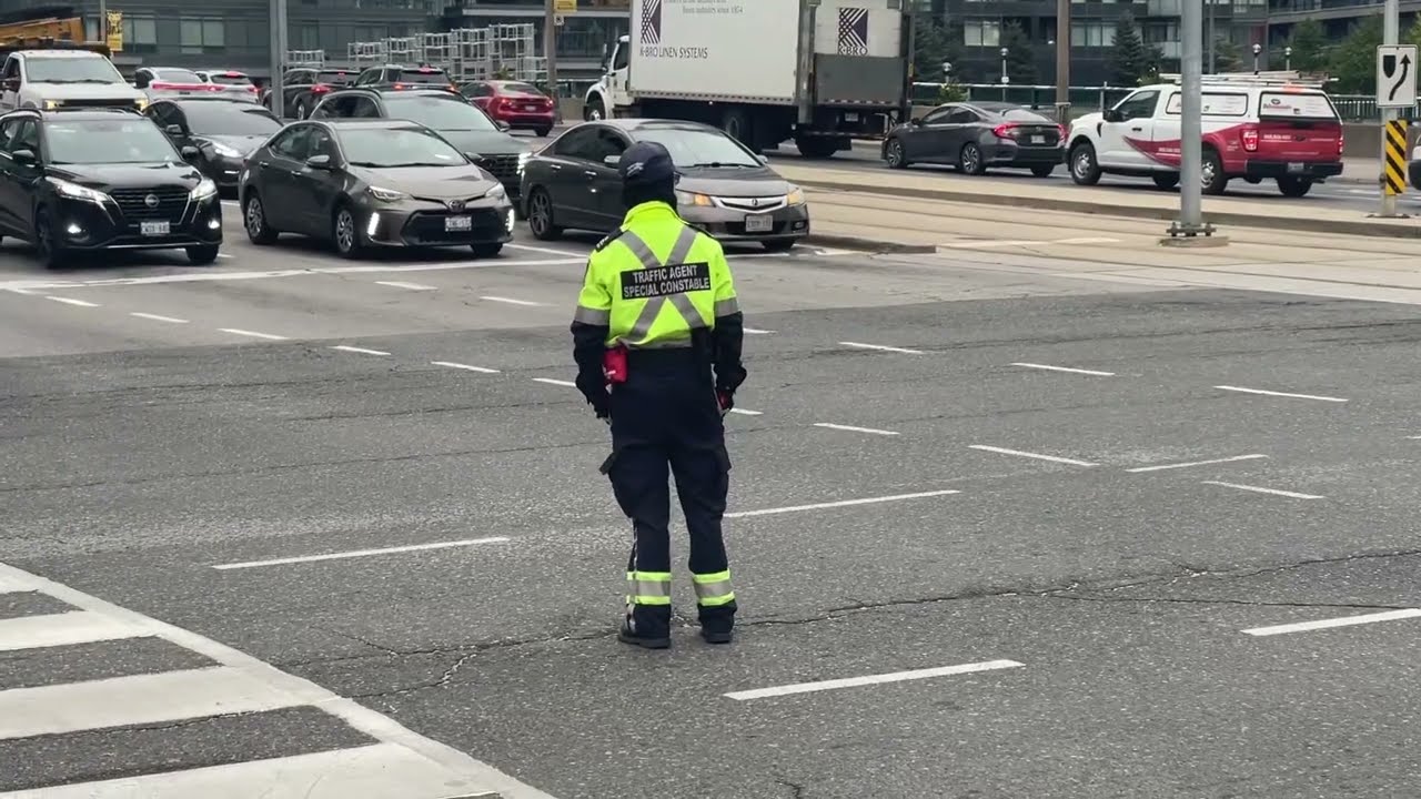 Directing busy traffic at Front & Spadina intersection - Toronto Canada October 25, 2024