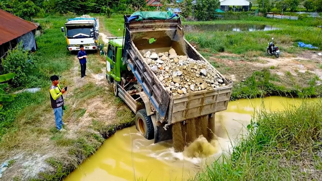 Bulldozer Power in action pour stone fall in ponf