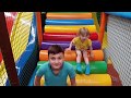 Alena and Pasha are playing at the indoor playground for children