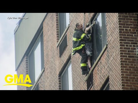Firefighters rescue woman dangling from 16th-floor window l GMA