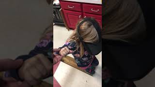 Girl walks across piece of wood wearing VR virtual reality glasses then dad gives her a push