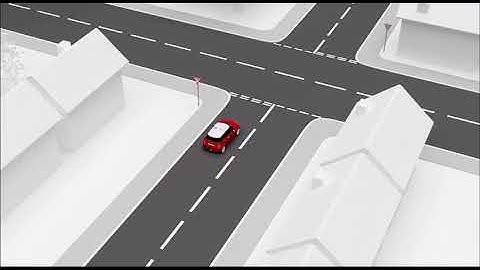 Cross roads with car emerging and following road ahead