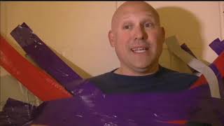 Goodrich Middle School students tape officer to wall as part of fundraising challenge