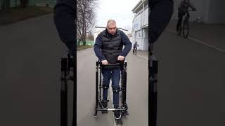 Paraplegic walks in an exoskeleton.