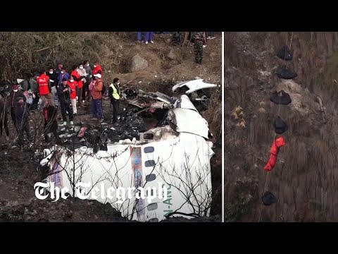 Nepal plane crash: rescue team search through wreckage for victims' bodies