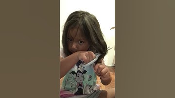 Thumbnail of Adorable five year old caught cutting her own hair