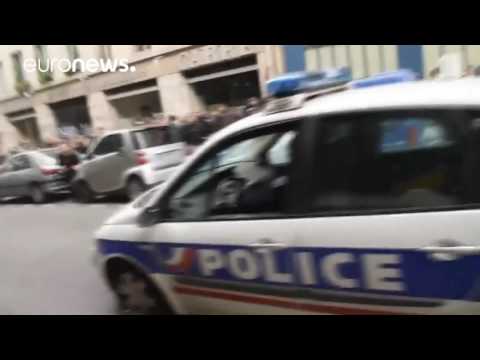 Paris protesters set police car on fire with 2 officers inside