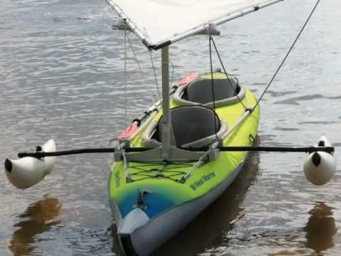 Inflatable kayak with crab claw sail and outriggers - YouTube