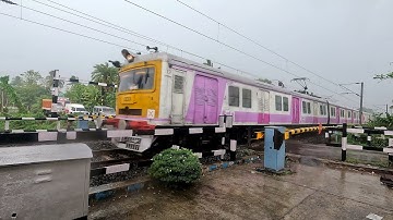 High Speedy Accelerating EMU Local Train Moving Furiously Moving out Rail Gate in Rainy Day