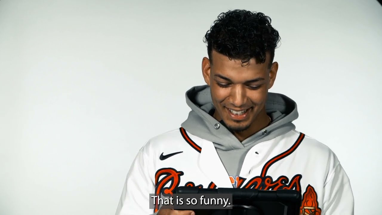 Ozzie Albies of the Atlanta Braves laughs in the dugout during the