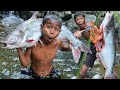 Primitive technology  catch big fish at waterfall cooking share for eat  eating show