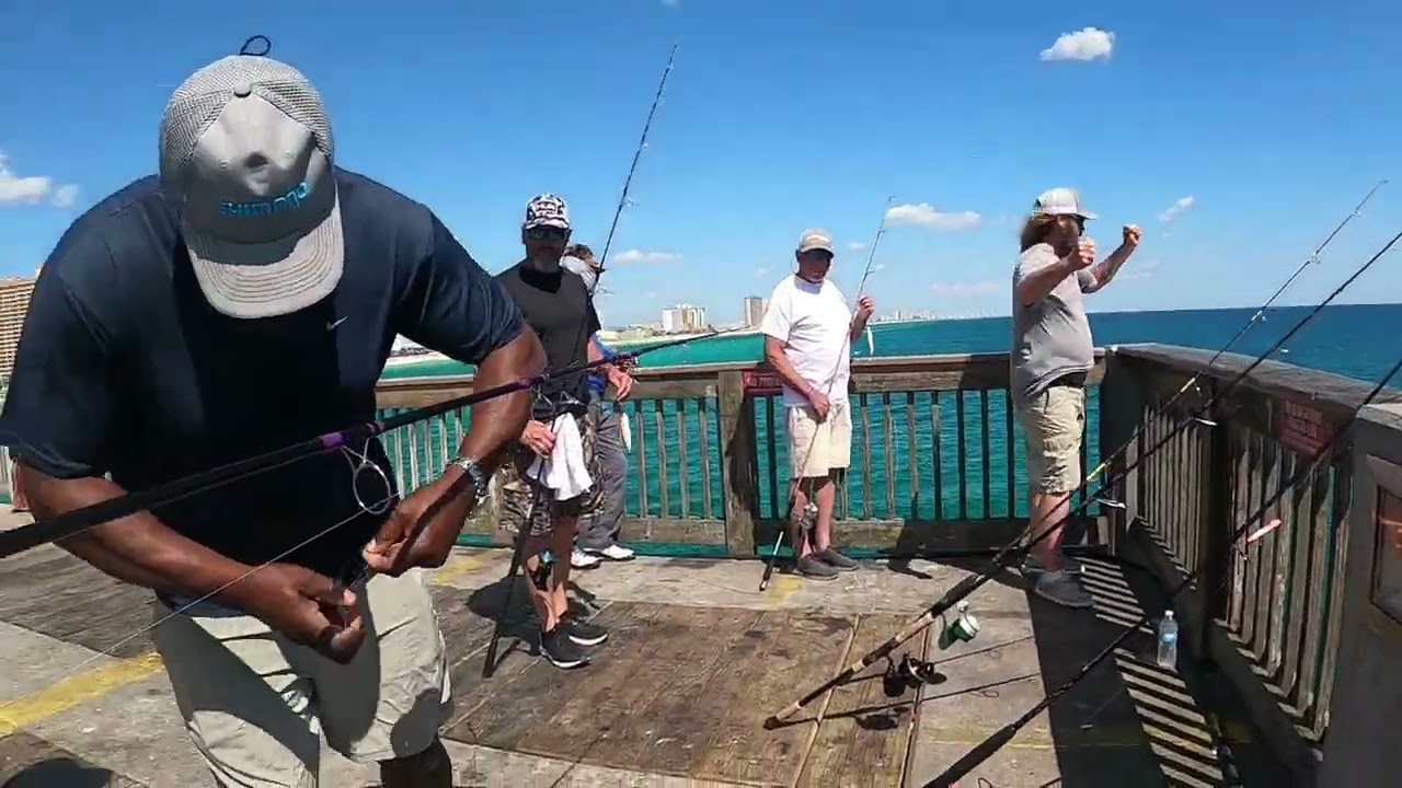 Sometimes it takes a whole team to catch a king mackerel at the pier