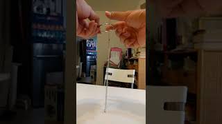 Chain and ring dropping magic connection trick, slow motion