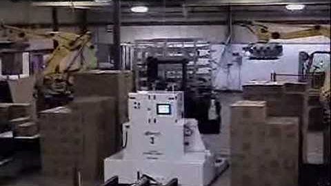 Large end of line unitizing system utilizing robots and AGV