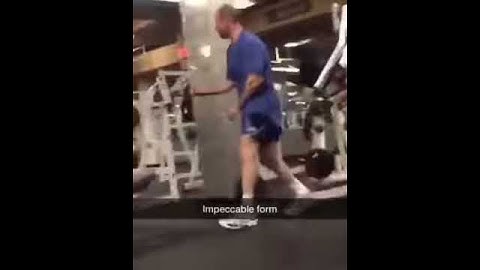 Bald guy gym machine impeccable form