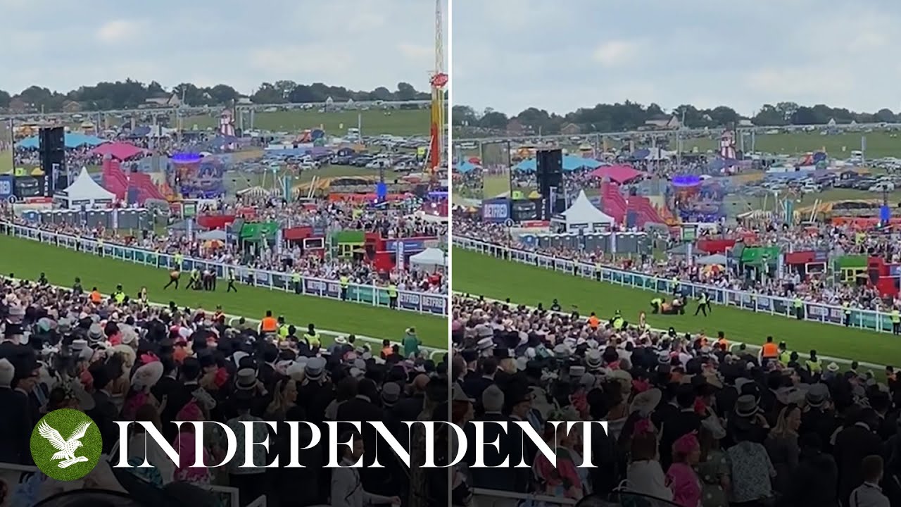 Epsom Derby Festival protester swarmed by guards and dragged off racecourse after running onto track