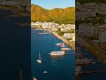 Vertical video. Marmaris, Turkey. Leisure vessel at pier with waterfront cafes and hotels in soft...