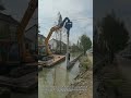 Incredible Riverbank Piling Work: Watch This Excavator Drive Piles Like a Pro!