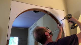 Installing a curved arch in a standard doorway.