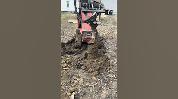 Ditch Witch using the auger attachment