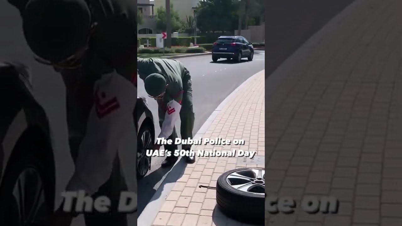 Dubai Police Officers Help Out A Woman With Changing The Tyres