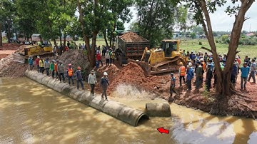 Nicely Skilled bulldozer Pushing Gravel Clearing Water To build Foundation road with 5Ton dump truck